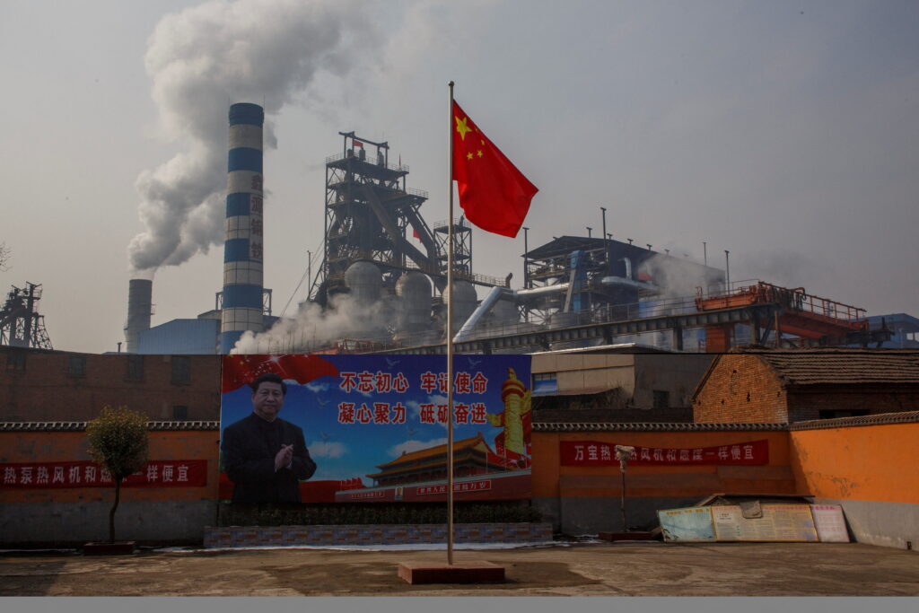 FILE PHOTO: A poster showing Chinese President Xi Jinping is seen in front of the Xinyuan Steel plant in Anyang